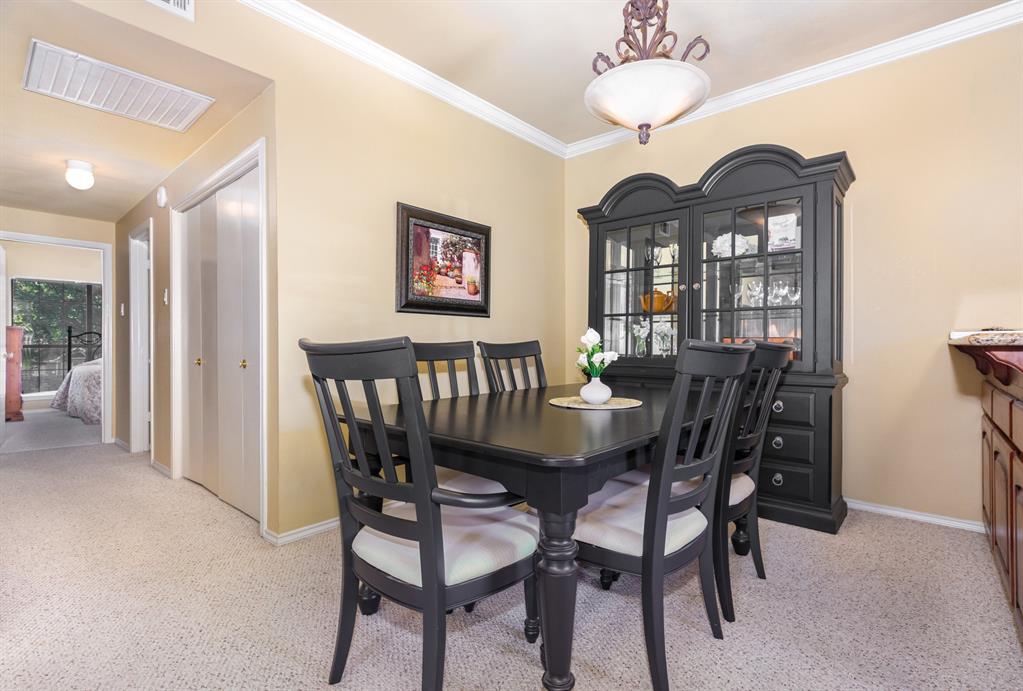 5859 Frankford Road, Unit 802 Dallas, TX 75252 - Photo 10 of 33 a view of a dining room with furniture wooden floor and a chandelier