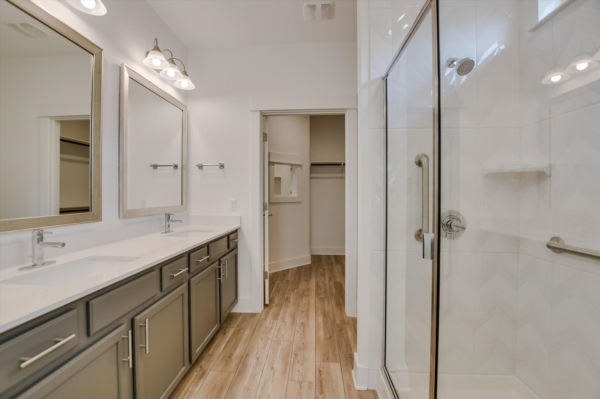 702 Kitty Hawk Road Georgetown, TX 78633 - Photo 14 of 21 a spacious bathroom with a granite countertop sink mirror and a shower