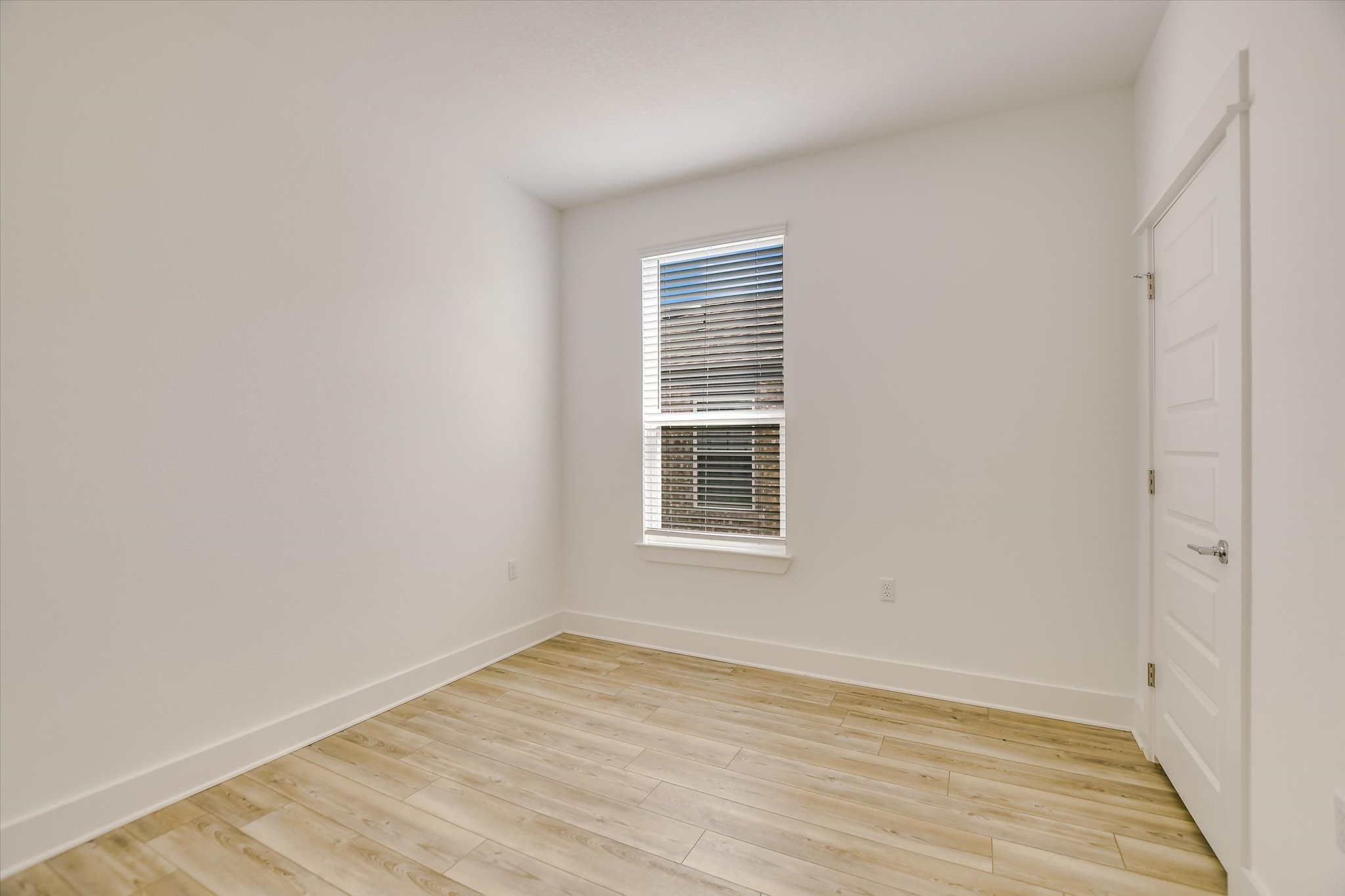 702 Kitty Hawk Road Georgetown, TX 78633 - Photo 16 of 21 a view of an empty room with wooden floor and a window