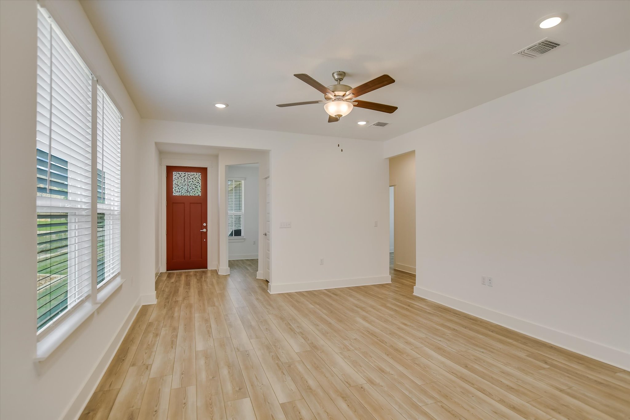 702 Kitty Hawk Road Georgetown, TX 78633 - Photo 4 of 21 a view of empty room with wooden floor and fan