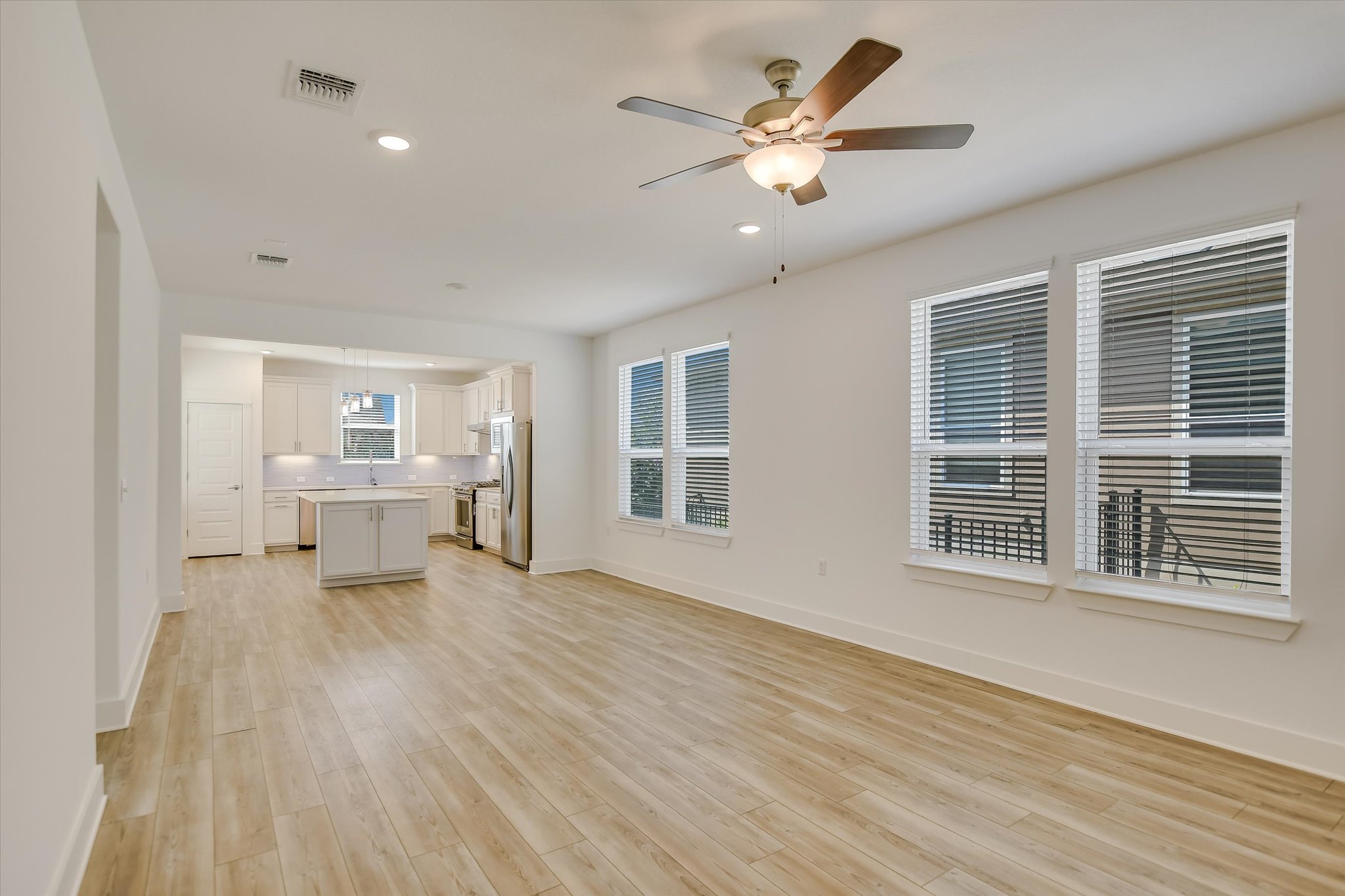 702 Kitty Hawk Road Georgetown, TX 78633 - Photo 5 of 21 a view of an empty room with a window and wooden floor