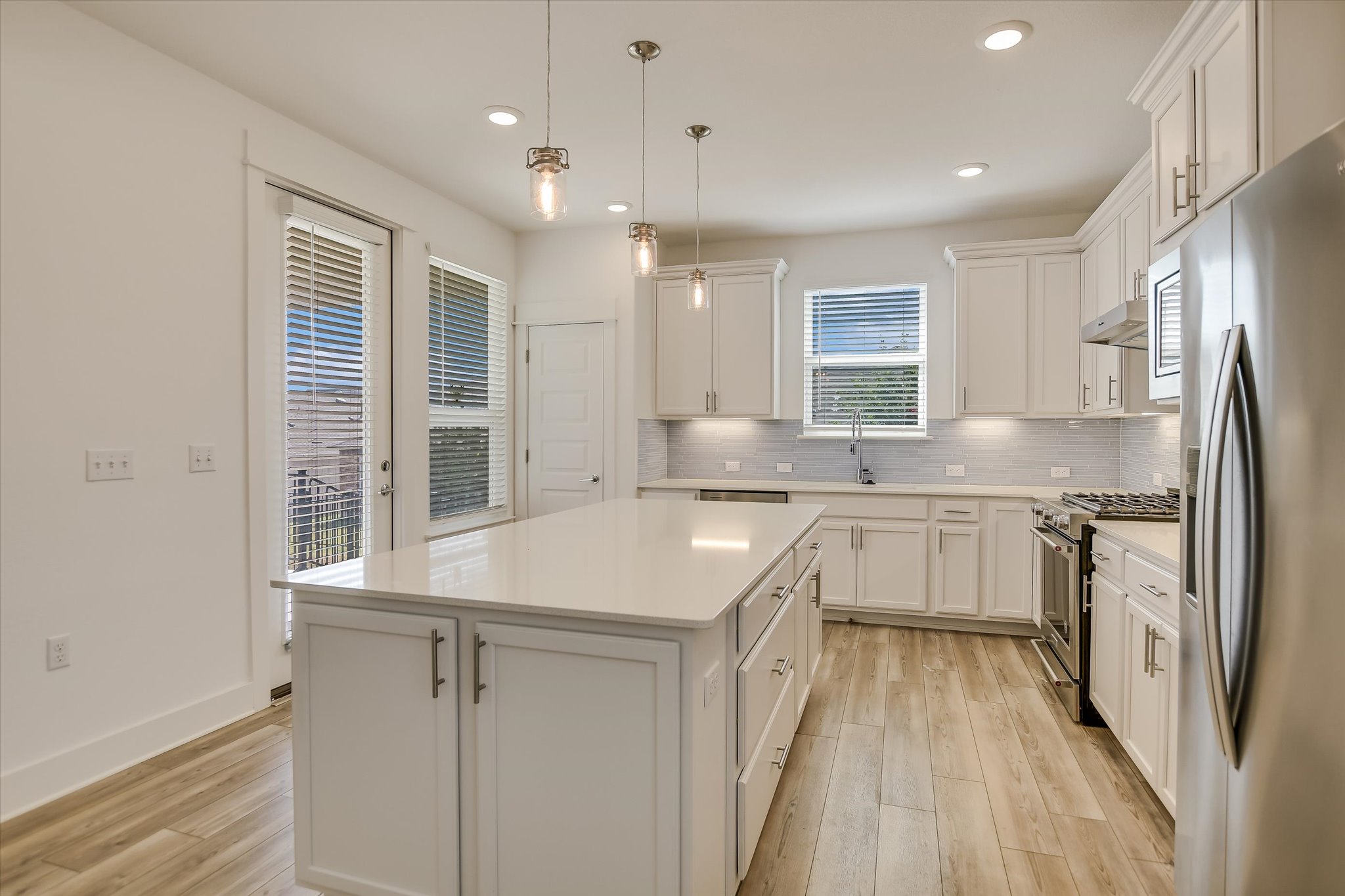702 Kitty Hawk Road Georgetown, TX 78633 - Photo 8 of 21 a kitchen with a sink stove and refrigerator