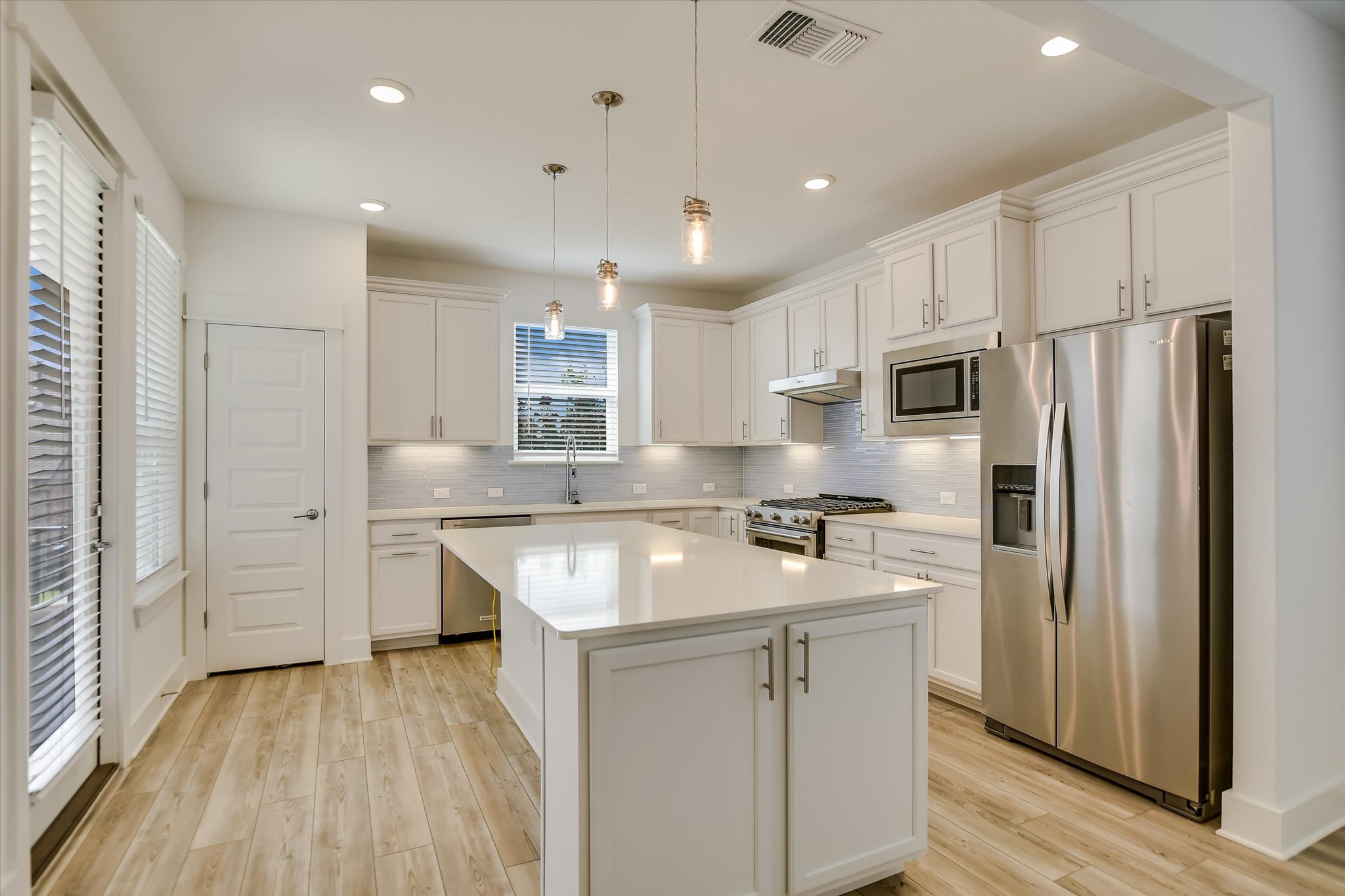 702 Kitty Hawk Road Georgetown, TX 78633 - Photo 9 of 21 a kitchen with kitchen island a sink stove and refrigerator