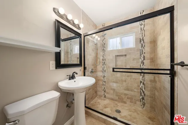 a bathroom with a sink toilet and shower