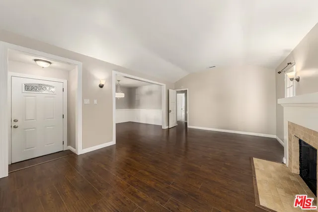 wooden floor in an empty room with a fireplace