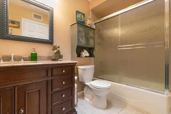 a bathroom with a toilet sink and shower