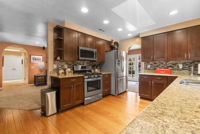 23452 Barona Mesa Road Ramona, CA 92065 - Photo 20 of 27 a kitchen with stainless steel appliances granite countertop a refrigerator stove and oven
