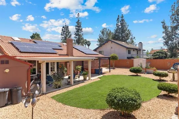 a view of a house with backyard and porch