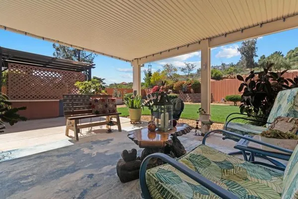 a outdoor living space with furniture potted plant and a large window