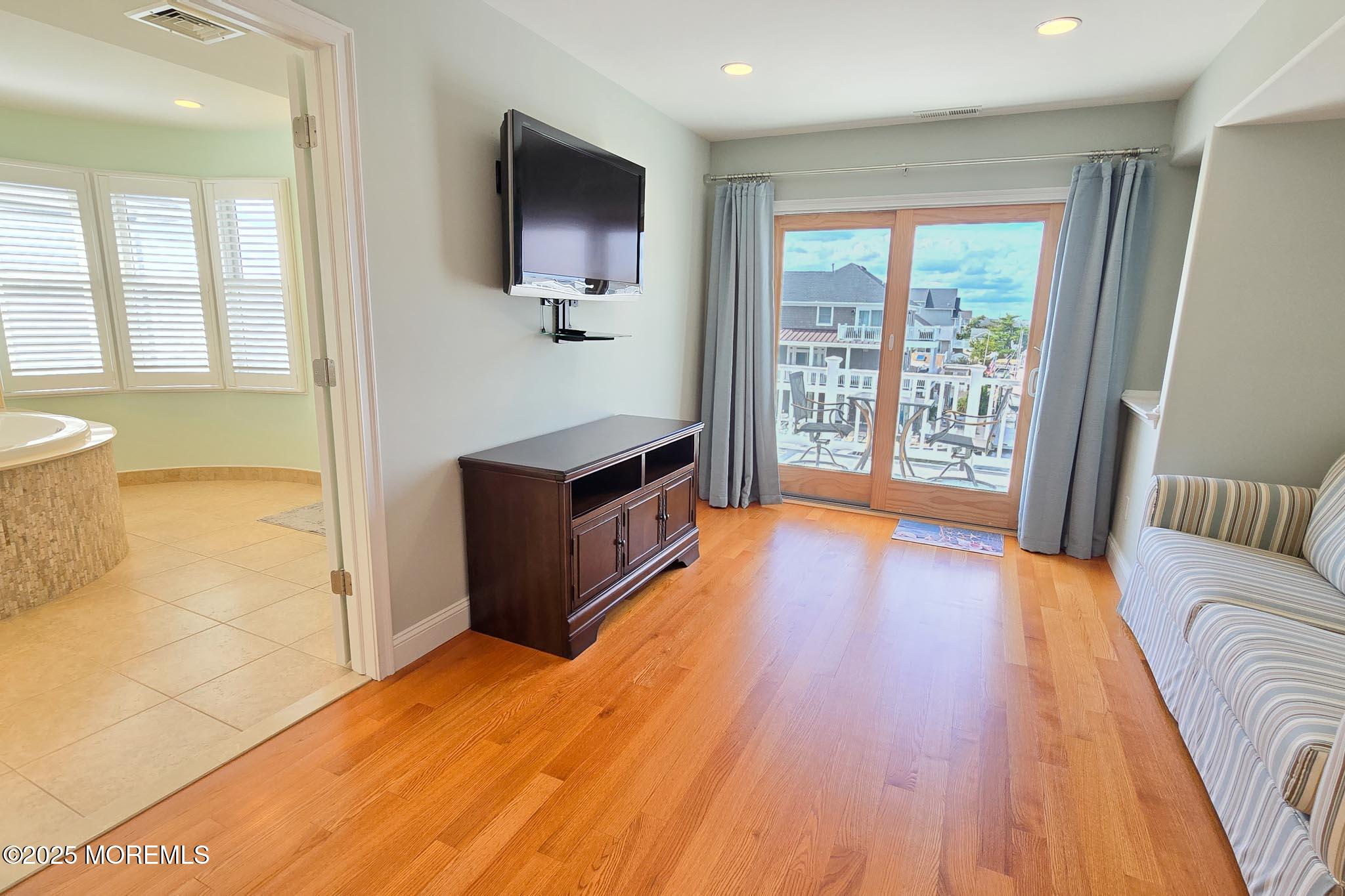 417 Delray Drive Lavallette, NJ 08735 - Photo 30 of 71 a living room with stainless steel appliances furniture a flat screen tv and a large window