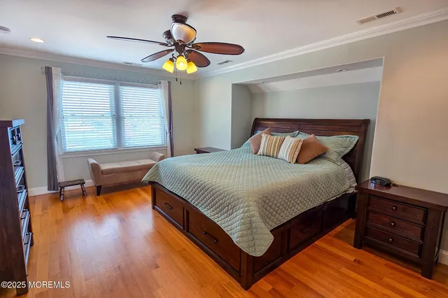 a kitchen with stainless steel appliances granite countertop a sink dishwasher and a stove with wooden floor