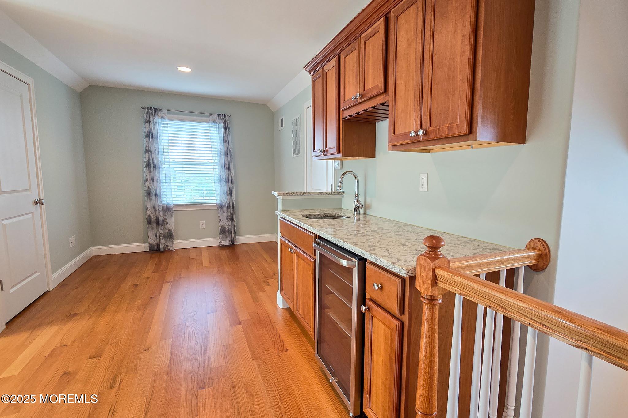 417 Delray Drive Lavallette, NJ 08735 - Photo 43 of 71 a kitchen with stainless steel appliances granite countertop a sink dishwasher and a stove with wooden floor