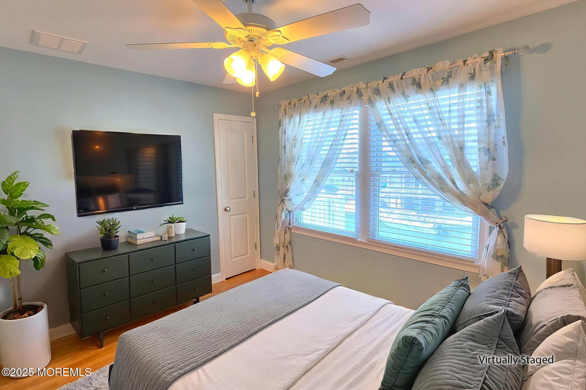 417 Delray Drive Lavallette, NJ 08735 - Photo 44 of 71 a bedroom with a bed and a flat screen tv