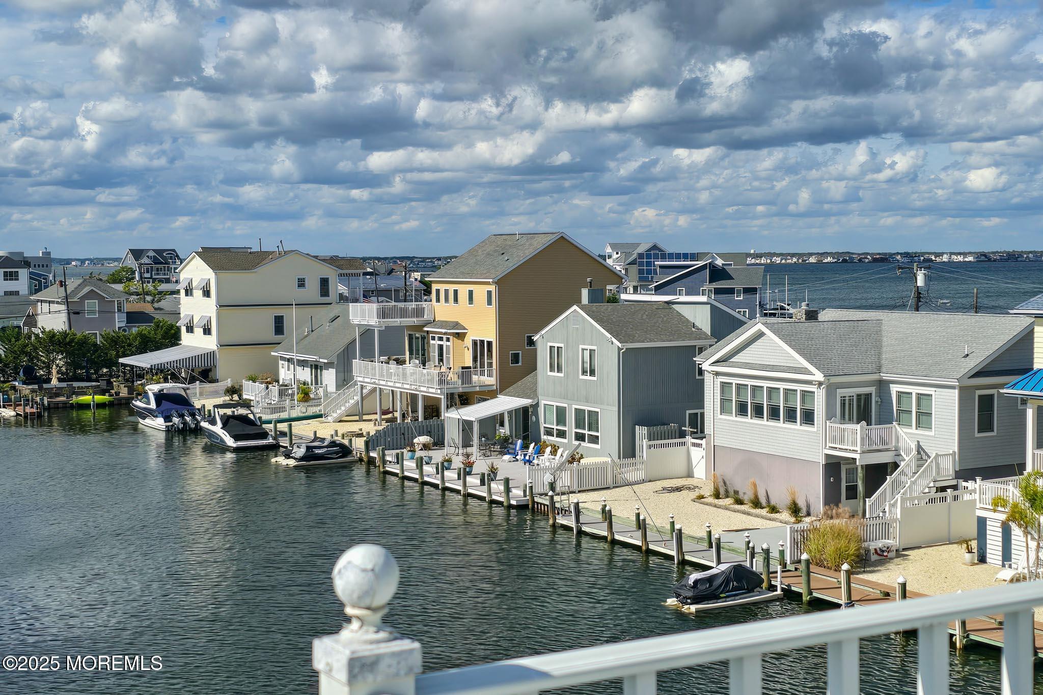 417 Delray Drive Lavallette, NJ 08735 - Photo 49 of 71 a view of a lake with a house in the background
