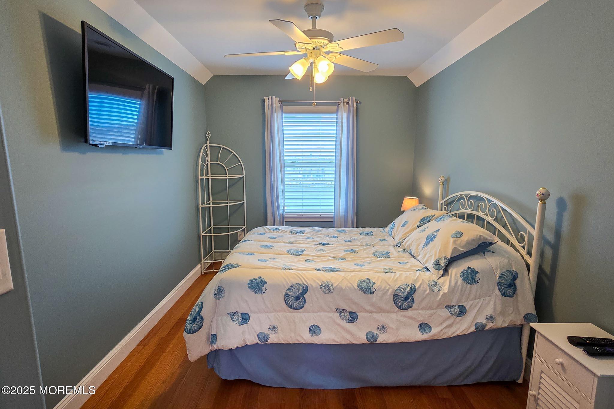 417 Delray Drive Lavallette, NJ 08735 - Photo 52 of 71 a bedroom with a bed and a chandelier