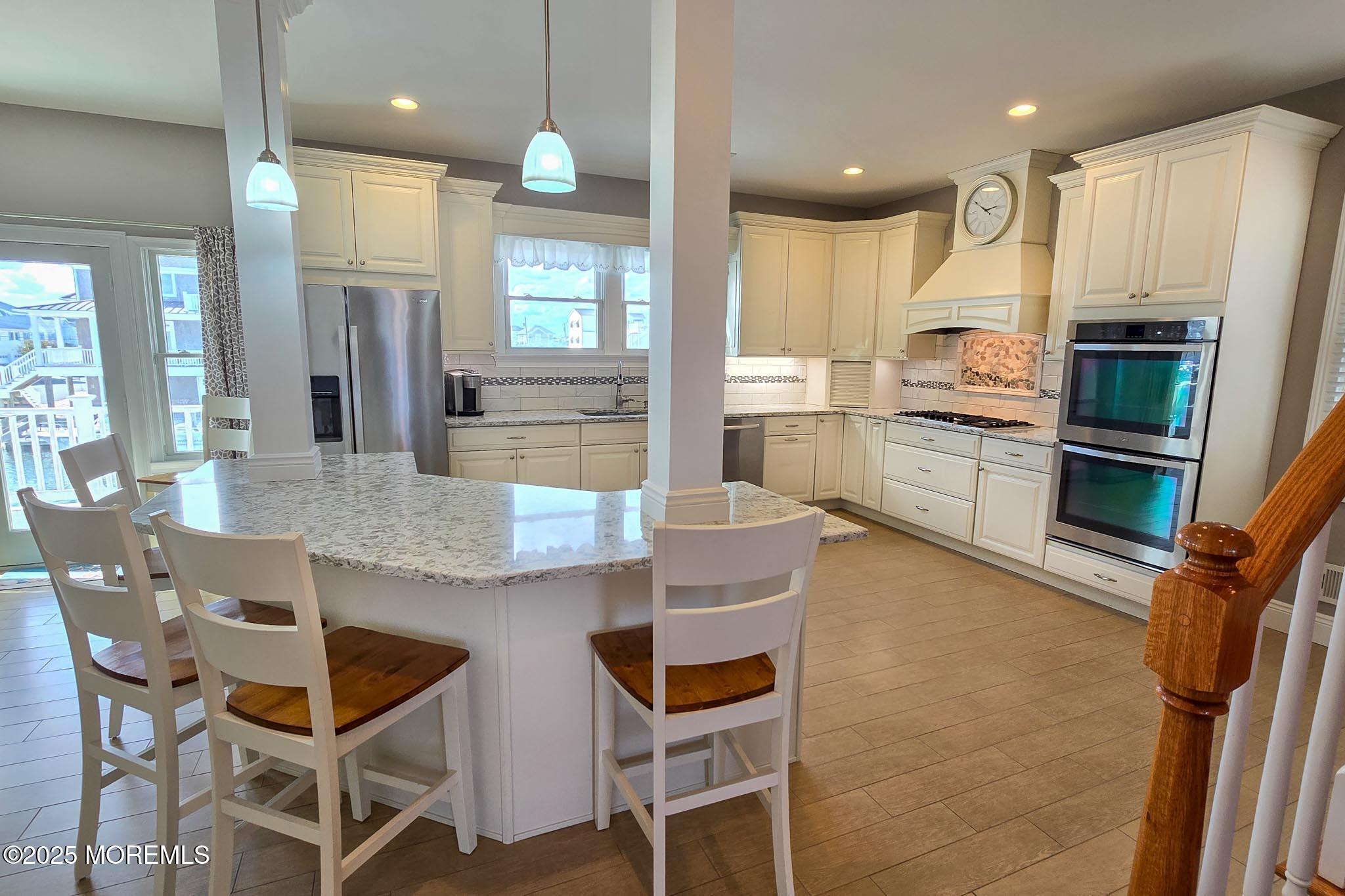 417 Delray Drive Lavallette, NJ 08735 - Photo 61 of 71 a kitchen with granite countertop cabinets and refrigerator