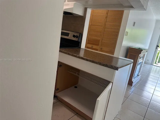 a view of a room with furniture and large windows