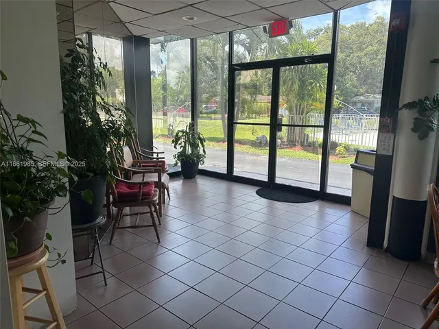 a view of a kitchen with a sink and refrigerator