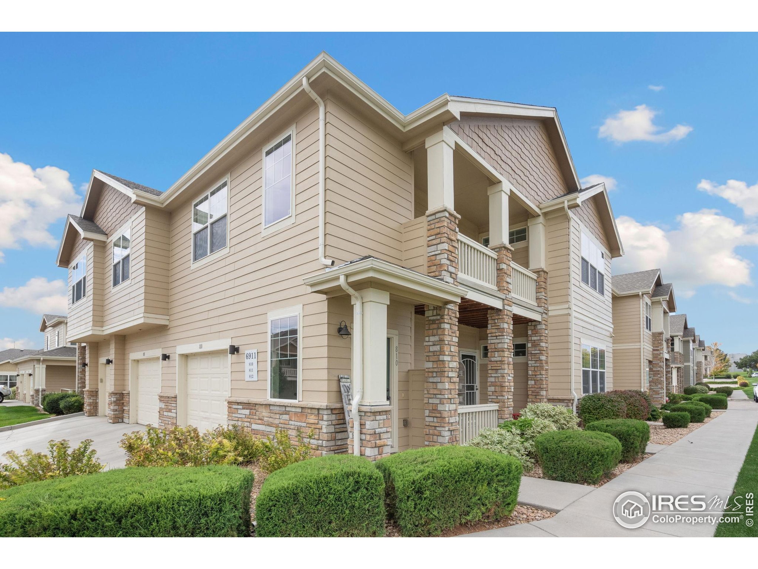 a view of a white house next to a yard