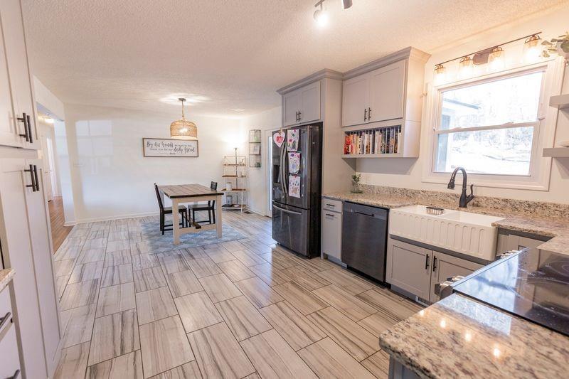 5028 Bird Road Gainesville, GA 30506 - Photo 11 of 34 a kitchen with stainless steel appliances granite countertop a refrigerator and a sink