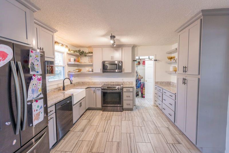 5028 Bird Road Gainesville, GA 30506 - Photo 13 of 34 a kitchen with stainless steel appliances a stove and a refrigerator