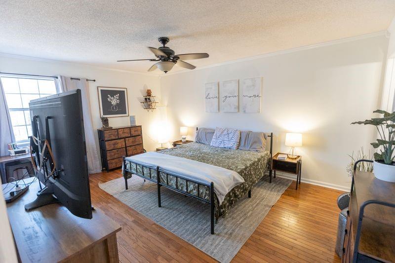 5028 Bird Road Gainesville, GA 30506 - Photo 14 of 34 a bedroom with a bed and wooden floor