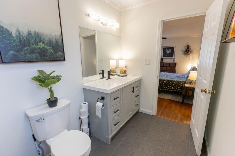 5028 Bird Road Gainesville, GA 30506 - Photo 16 of 34 a bathroom with a sink vanity and a mirror