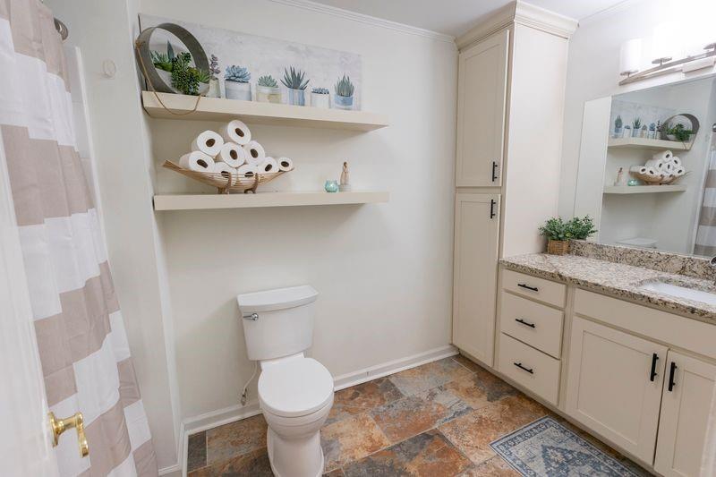 5028 Bird Road Gainesville, GA 30506 - Photo 21 of 34 a bathroom with a toilet sink and vanity