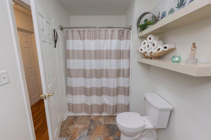 5028 Bird Road Gainesville, GA 30506 - Photo 22 of 34 a white toilet sitting next to a shower curtain