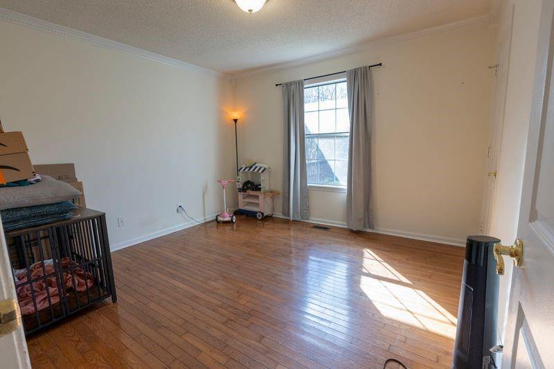 5028 Bird Road Gainesville, GA 30506 - Photo 24 of 34 an empty room with wooden floor cabinet and windows