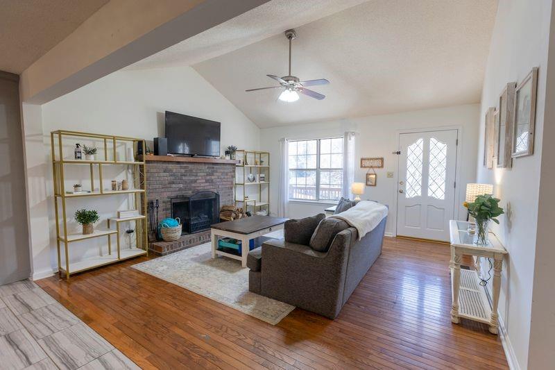 5028 Bird Road Gainesville, GA 30506 - Photo 6 of 34 a living room with furniture and a fireplace