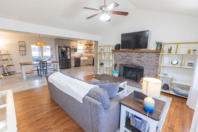 5028 Bird Road Gainesville, GA 30506 - Photo 8 of 34 a living room with furniture fireplace and a flat screen tv