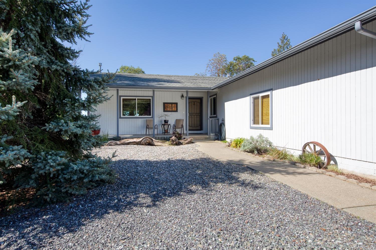 a view of a house with backyard and sitting area