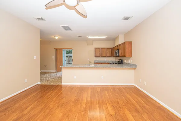 a view of kitchen with sink and wooden floor