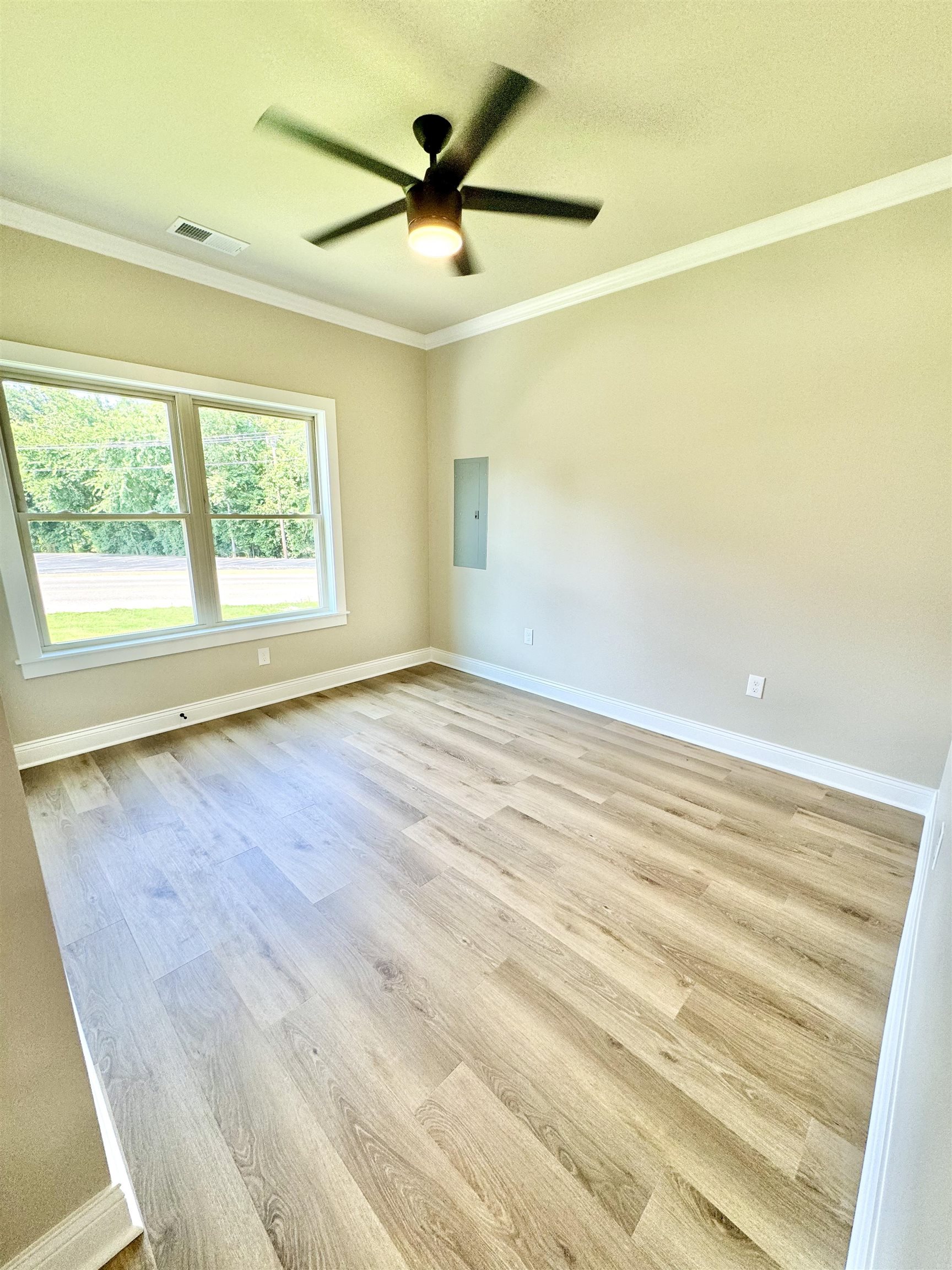 210 Church Street Ripley, TN 38063 - Photo 13 of 14 Spare room featuring ceiling fan, light wood-type flooring, and crown molding