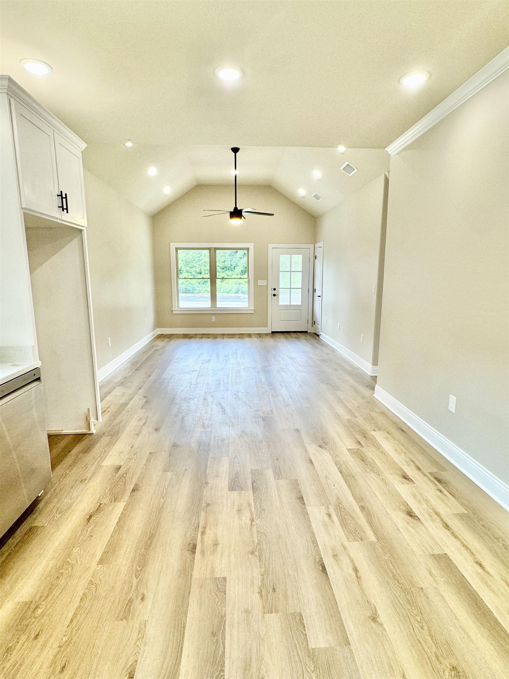 210 Church Street Ripley, TN 38063 - Photo 2 of 14 Unfurnished living room with ceiling fan, vaulted ceiling, and light hardwood / wood-style flooring