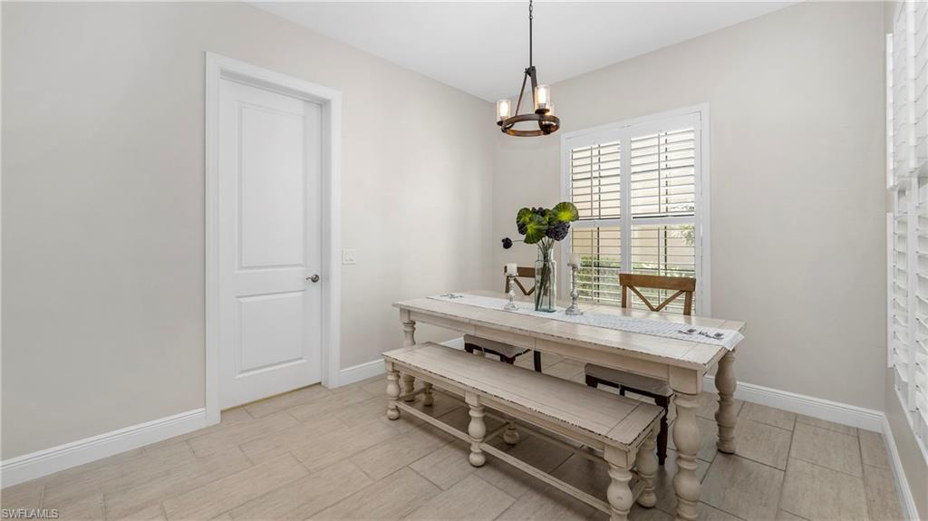 1238 Kendari Terrace Naples, FL 34113 - Photo 11 of 50 Dining room featuring suspended lighting and wood finish floors
