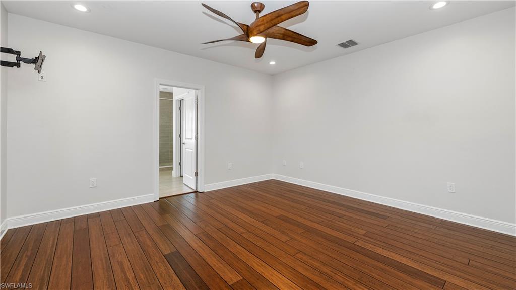 1238 Kendari Terrace Naples, FL 34113 - Photo 16 of 50 Empty room featuring a ceiling fan, dark wood-style flooring, and recessed lighting