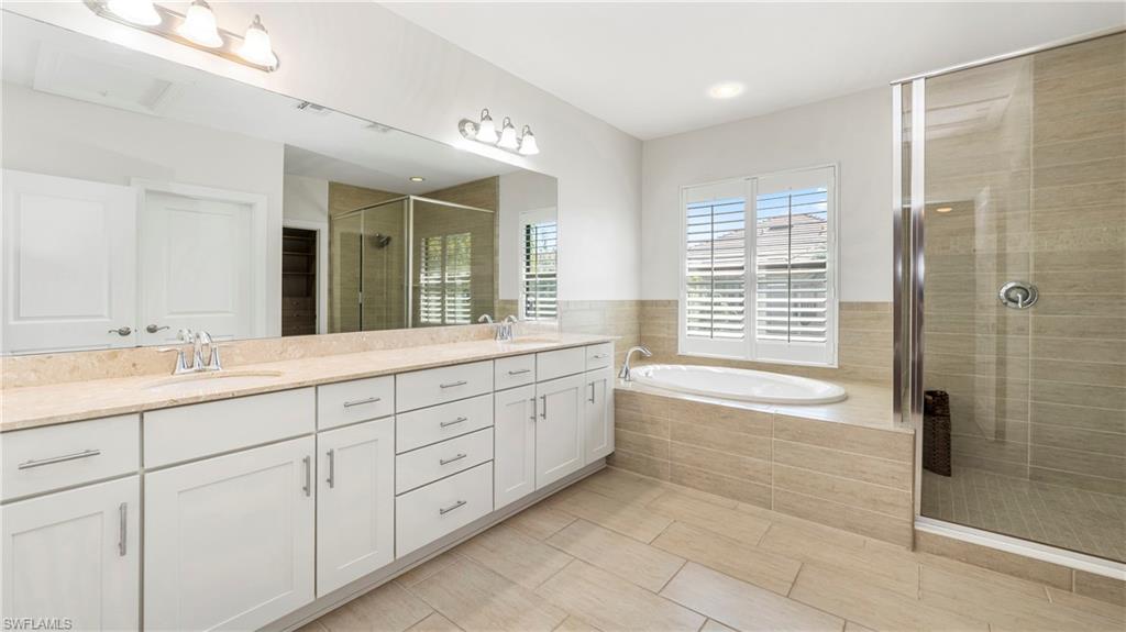 1238 Kendari Terrace Naples, FL 34113 - Photo 17 of 50 Full bath with a shower stall, a garden tub, and double vanity