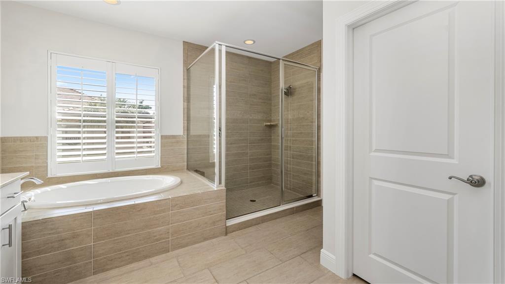 1238 Kendari Terrace Naples, FL 34113 - Photo 18 of 50 Bathroom with a shower stall, a garden tub, vanity, and recessed lighting