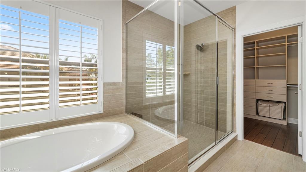 1238 Kendari Terrace Naples, FL 34113 - Photo 19 of 50 Full bath with a shower stall, a garden tub, a walk in closet, and tile patterned flooring