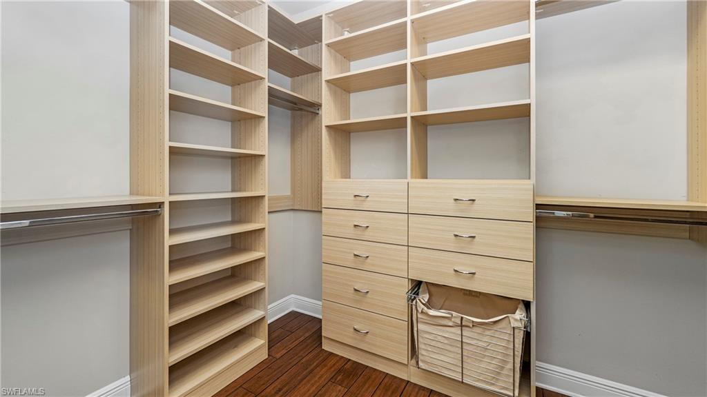 1238 Kendari Terrace Naples, FL 34113 - Photo 20 of 50 Walk in closet featuring dark wood-type flooring