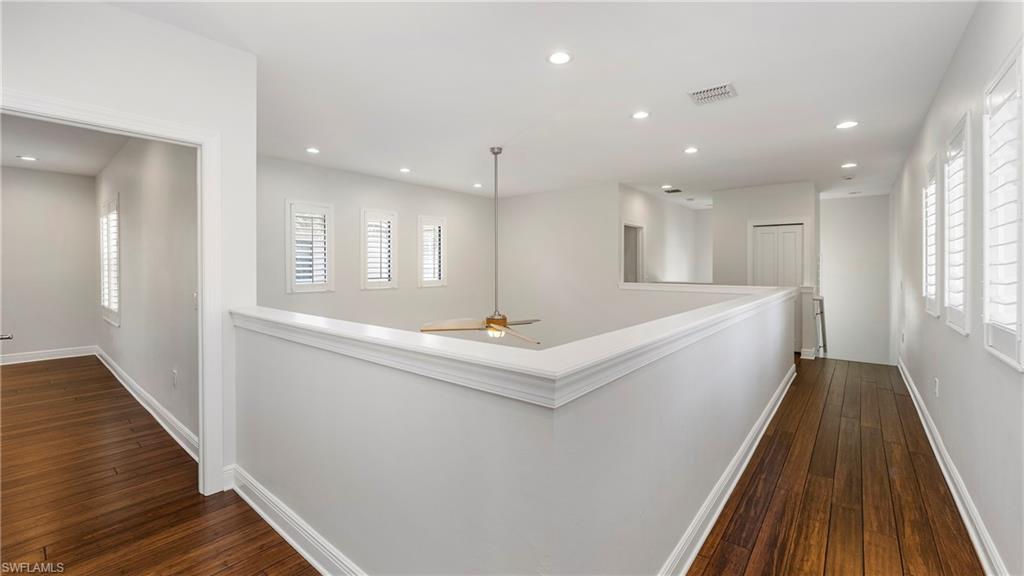 1238 Kendari Terrace Naples, FL 34113 - Photo 21 of 50 Hall with dark wood-style flooring, healthy amount of natural light, and recessed lighting