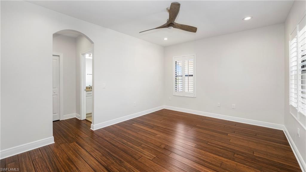 1238 Kendari Terrace Naples, FL 34113 - Photo 22 of 50 Unfurnished room featuring ceiling fan, dark wood-type flooring, arched walkways, and recessed lighting
