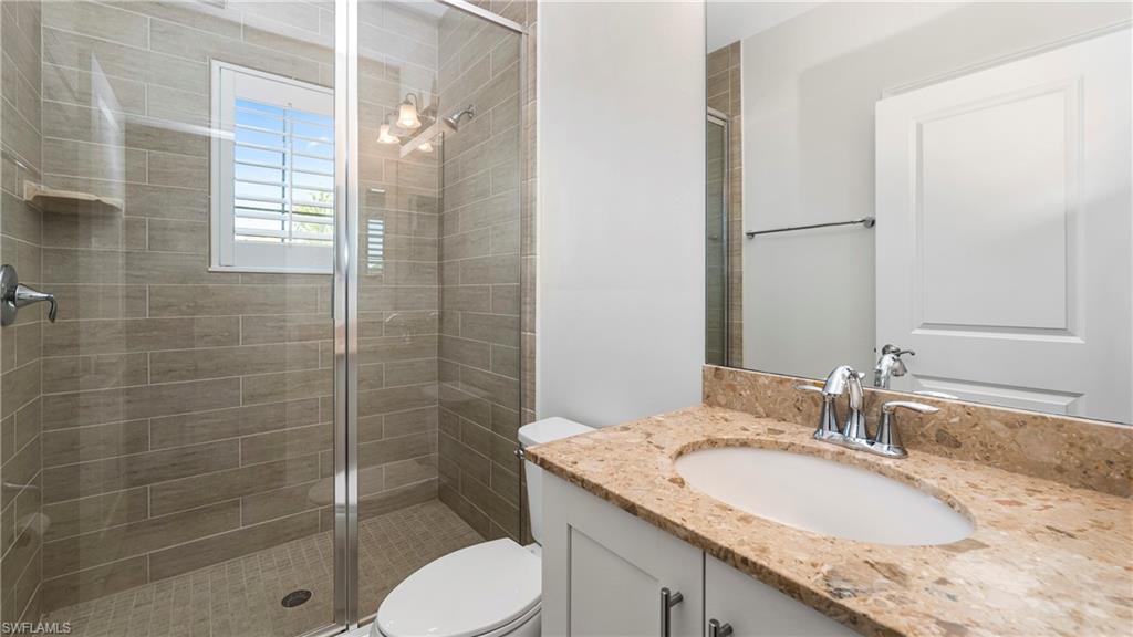 1238 Kendari Terrace Naples, FL 34113 - Photo 28 of 50 Full bathroom with vanity and a shower stall