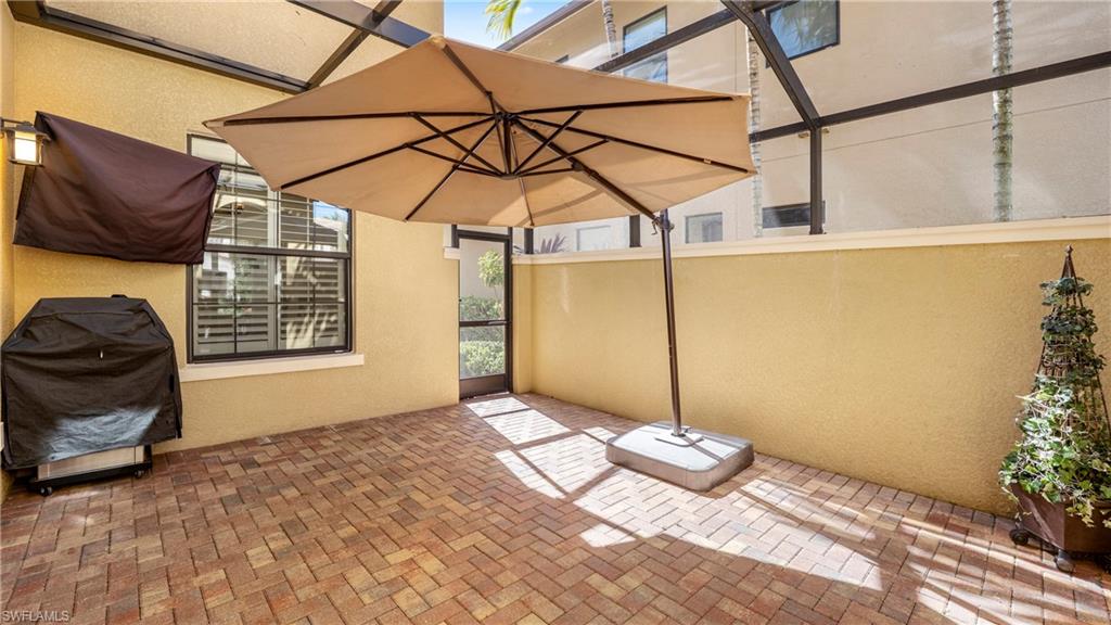 1238 Kendari Terrace Naples, FL 34113 - Photo 29 of 50 View of patio featuring area for grilling and glass enclosure