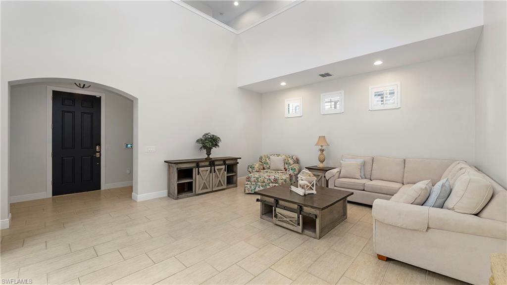 1238 Kendari Terrace Naples, FL 34113 - Photo 3 of 50 Living area with arched walkways, a high ceiling, and recessed lighting