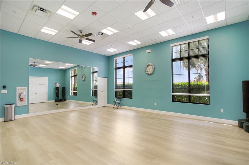 1238 Kendari Terrace Naples, FL 34113 - Photo 47 of 50 Exercise area with a ceiling fan and a paneled ceiling