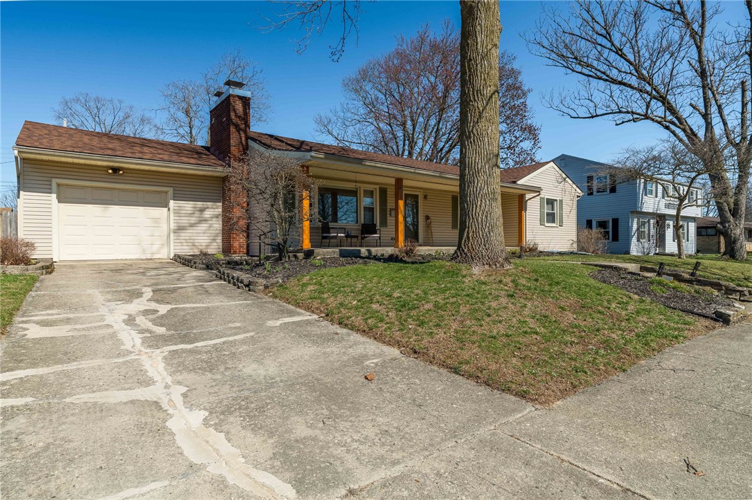 1463 Chelsea Road Troy, OH 45373 - Photo 2 of 39 This charming home offers a welcoming front porch and an attached garage, perfect for comfortable living.