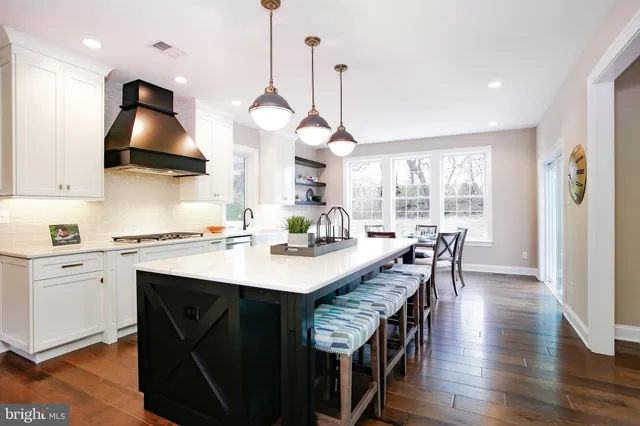 a living room with furniture a flat screen tv and a large window